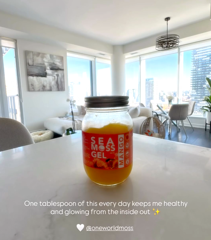 Jar of Sea Moss Gel on a kitchen counter with a cityscape view