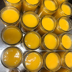 Jars filled with a yellow substance on a metal surface