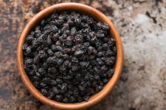 Bowl of dried whole elderberries for sale from World Moss with rich dark color and texture