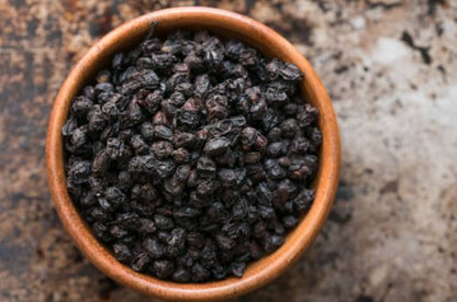 Bowl of dried whole elderberries for sale from World Moss with rich dark color and texture